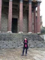 an image of michelle berenfeld standing in front of architectural columns